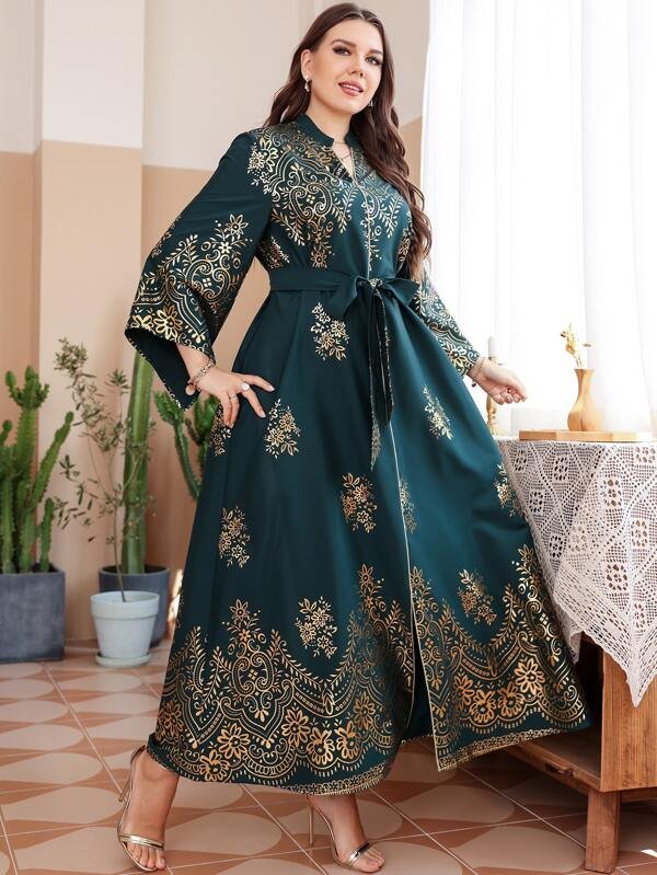 A dress with a belt and random flower print, in a plus size.