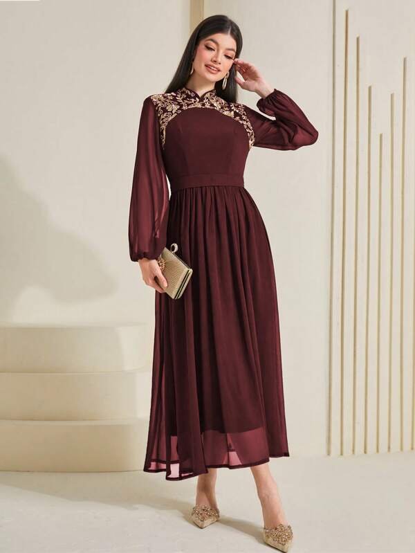 A dress with an A-line silhouette embroidered with contrasting floral mesh.