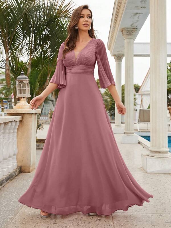 A bridesmaid dress with a plunging neckline, puffed sleeves, and chiffon fabric