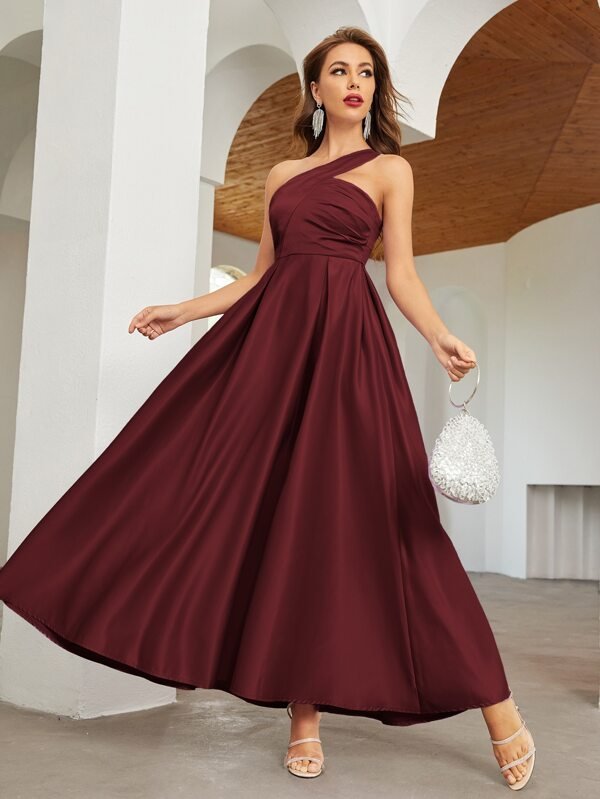 A bridesmaid dress with a one-shoulder design in a solid color, maxi length